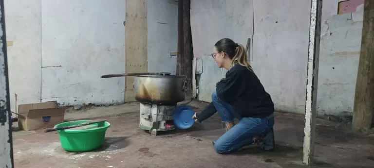 Bailey cooking outdoors during an African adventure with B. Adventuras