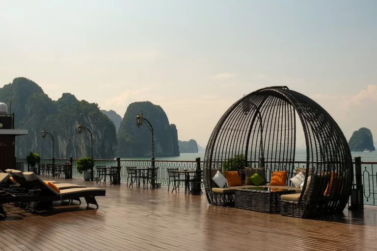 Ha Long Bay Vietnam limestone cliffs with boats on emerald water